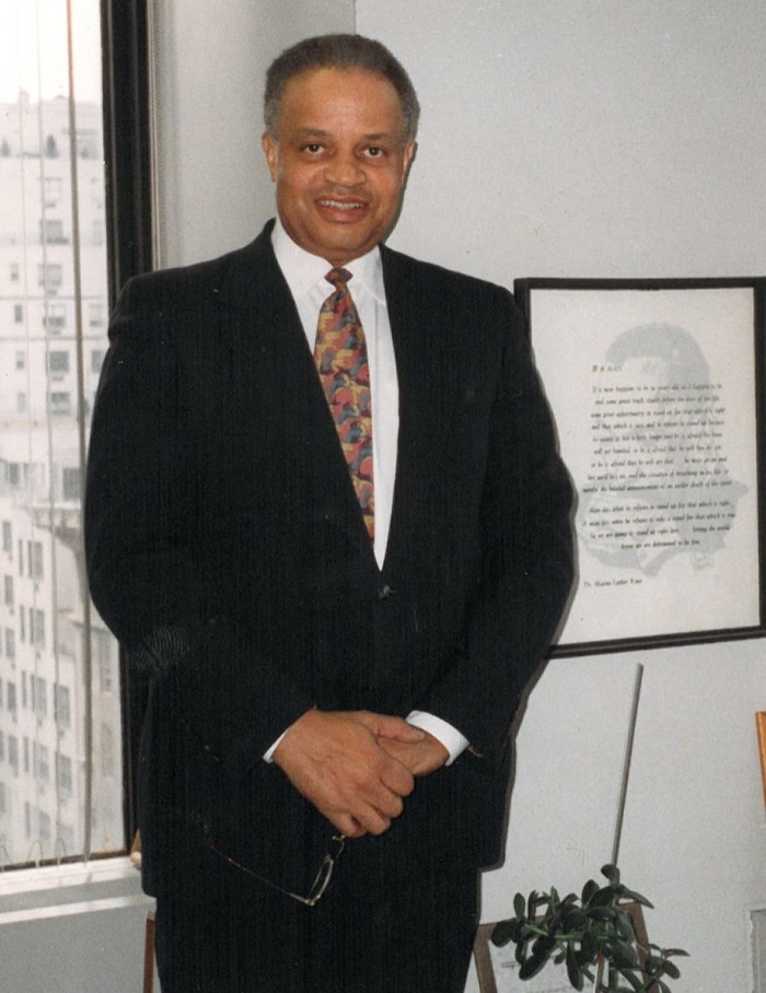 Dr. Hugh Jerome Scott standing in his office at Hunter College